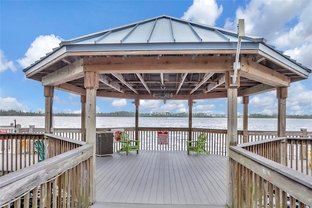 wooden terrace featuring a water view and a gazebo