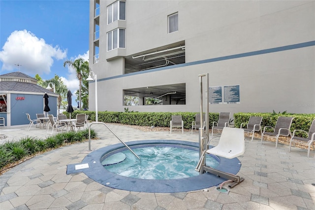 view of swimming pool with a community hot tub and a patio area