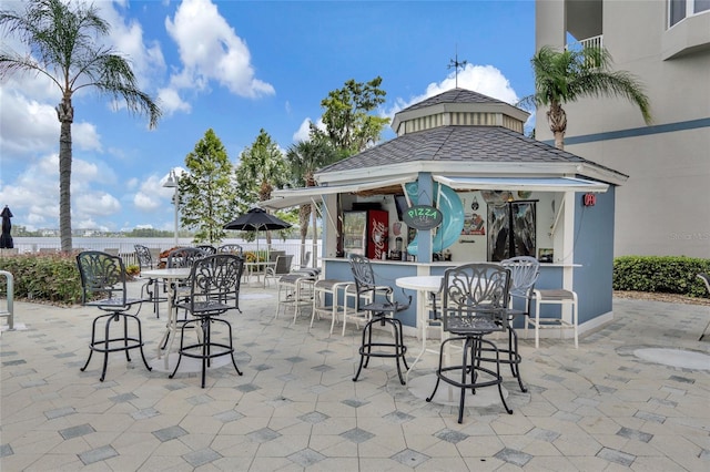 view of patio with fence, a gazebo, and exterior bar