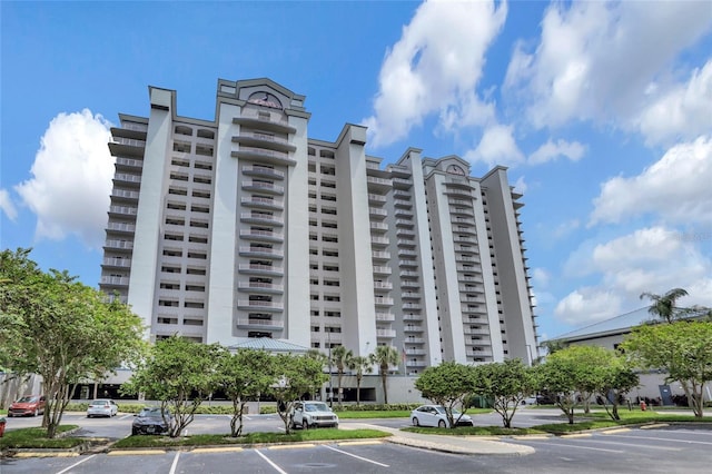 view of building exterior featuring uncovered parking