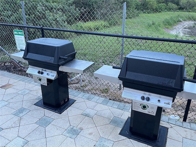 view of patio / terrace with a grill and fence