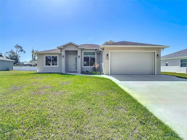 view of front of property featuring a garage and a front yard