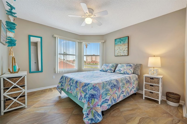 bedroom featuring ceiling fan and a textured ceiling