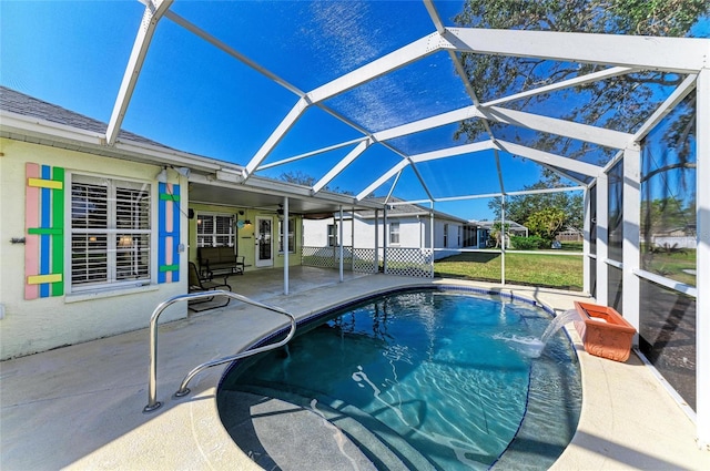 outdoor pool with glass enclosure and a patio area