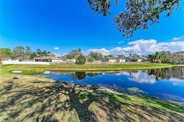 water view featuring fence and a residential view