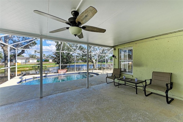 view of pool with a water view, a patio, a lanai, and ceiling fan