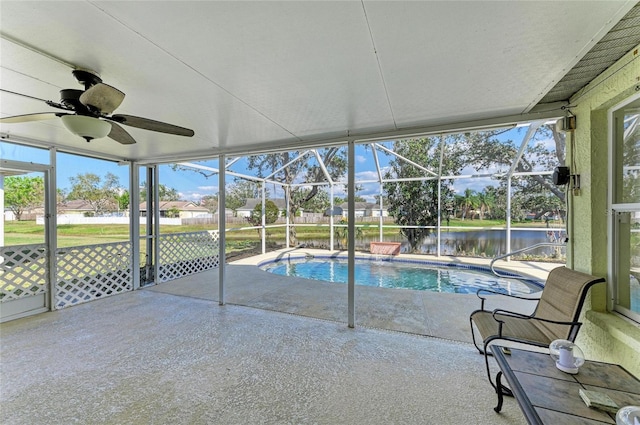 pool with glass enclosure, a patio, and a ceiling fan