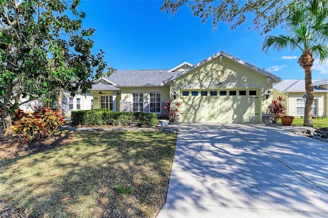 single story home featuring a garage, driveway, a front lawn, and stucco siding