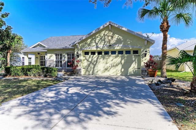 ranch-style house featuring stucco siding, driveway, and a garage