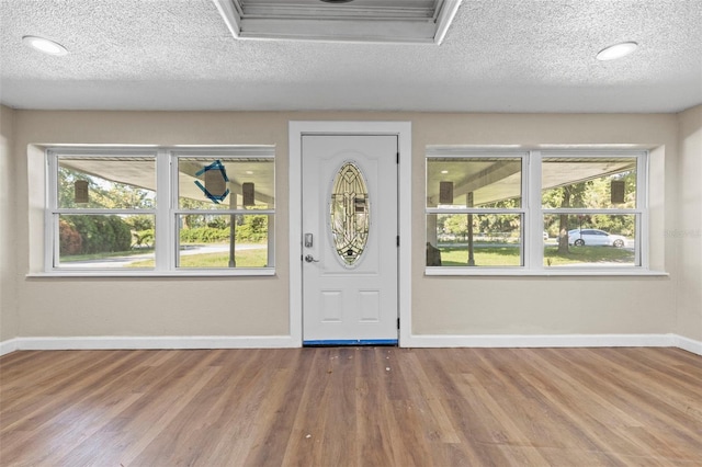 entryway with hardwood / wood-style floors and a healthy amount of sunlight