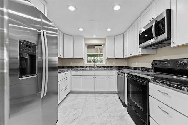 kitchen with white cabinets and appliances with stainless steel finishes