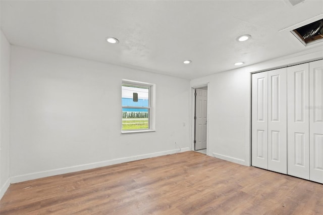 unfurnished bedroom featuring a closet and light hardwood / wood-style flooring