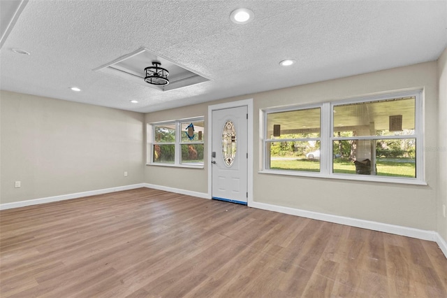 foyer featuring a textured ceiling and light wood-type flooring