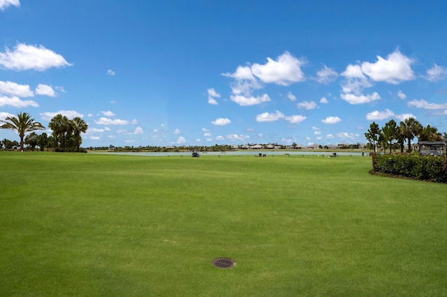 view of community featuring a lawn and a water view