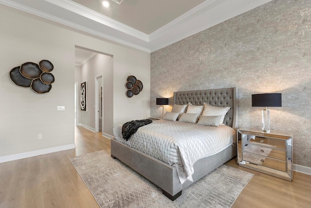 bedroom featuring ornamental molding and hardwood / wood-style floors