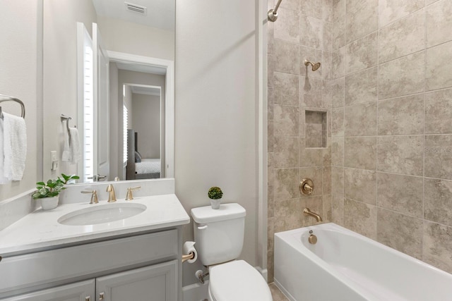 full bathroom featuring vanity, toilet, and tiled shower / bath combo