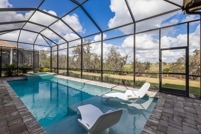 view of swimming pool featuring an in ground hot tub, glass enclosure, and a patio area