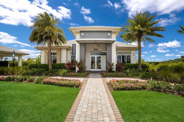 exterior space featuring a lawn and french doors