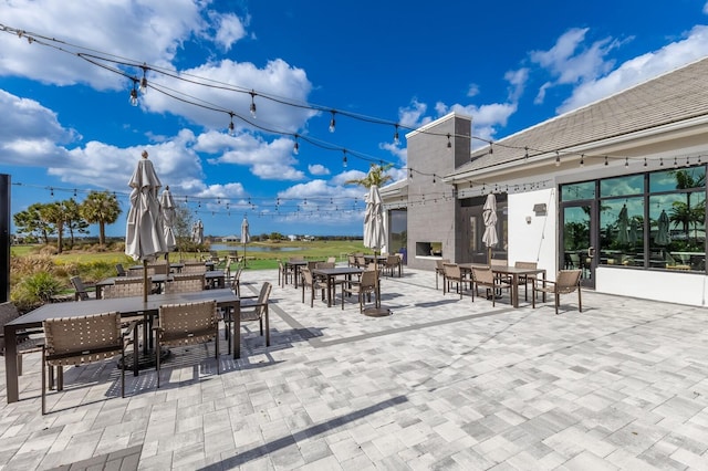 view of patio with exterior fireplace