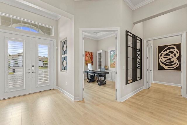 entryway with french doors, ornamental molding, and light wood-type flooring