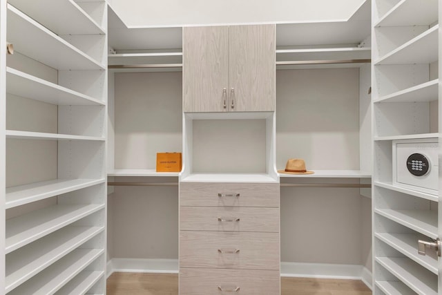 spacious closet featuring light hardwood / wood-style flooring