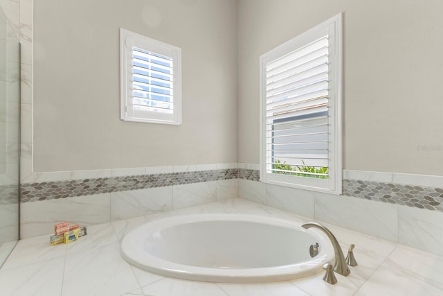 bathroom with tiled bath