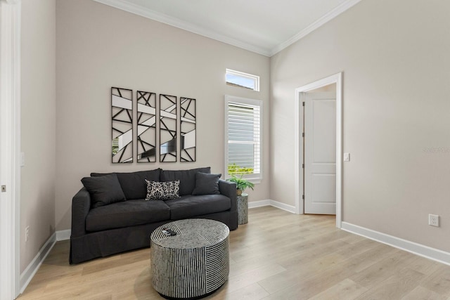 living room with ornamental molding, plenty of natural light, and light hardwood / wood-style flooring