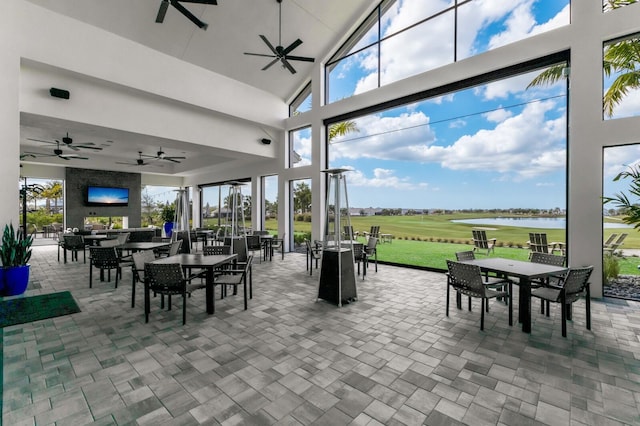 interior space featuring a patio, a water view, and ceiling fan