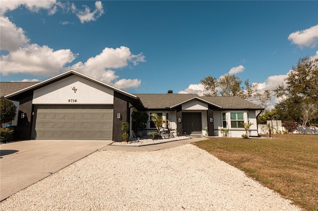 ranch-style house featuring a garage and a front yard