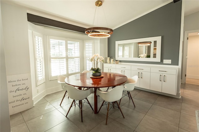 dining room featuring lofted ceiling, light tile patterned floors, and baseboards