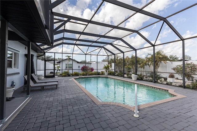 view of pool with a lanai, a fenced in pool, and a patio