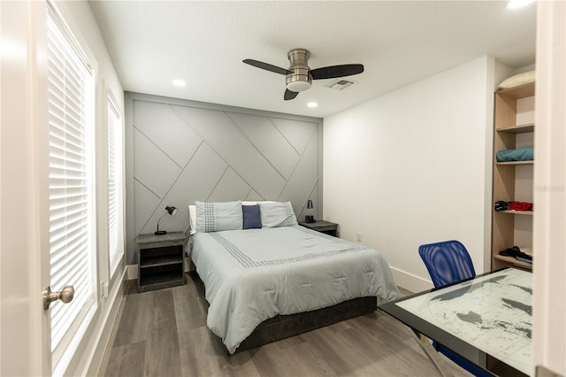 bedroom with ceiling fan, visible vents, wood finished floors, and recessed lighting