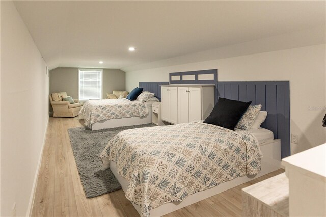 bedroom with lofted ceiling, light wood-style floors, and recessed lighting