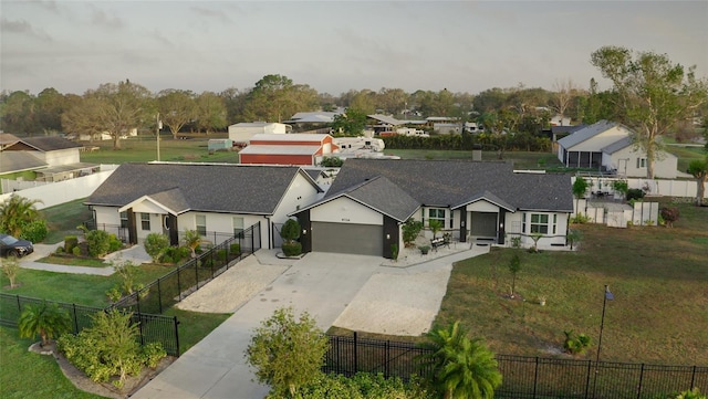 view of front of property with a residential view, fence, a front lawn, and concrete driveway