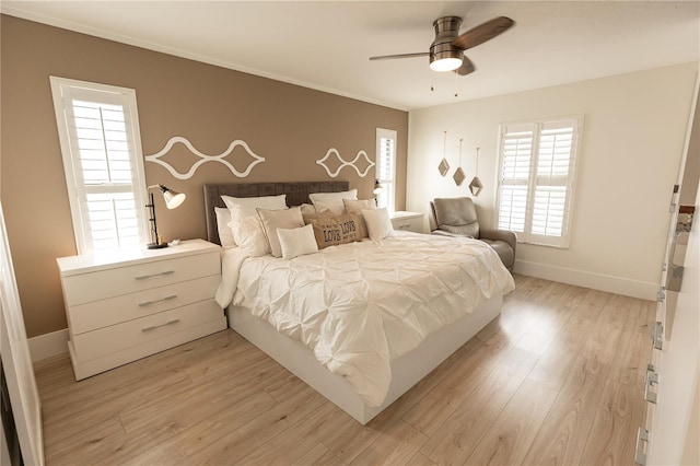 bedroom with baseboards, ceiling fan, and light wood finished floors