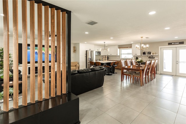 living room with light tile patterned floors, recessed lighting, visible vents, french doors, and an inviting chandelier