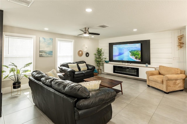 living area featuring a ceiling fan, light tile patterned flooring, visible vents, and recessed lighting