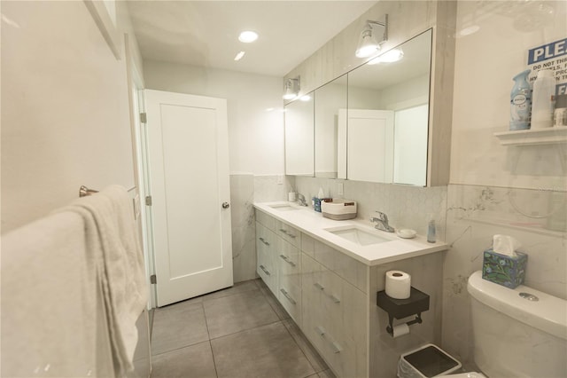 full bathroom with tile patterned flooring, a sink, toilet, and double vanity