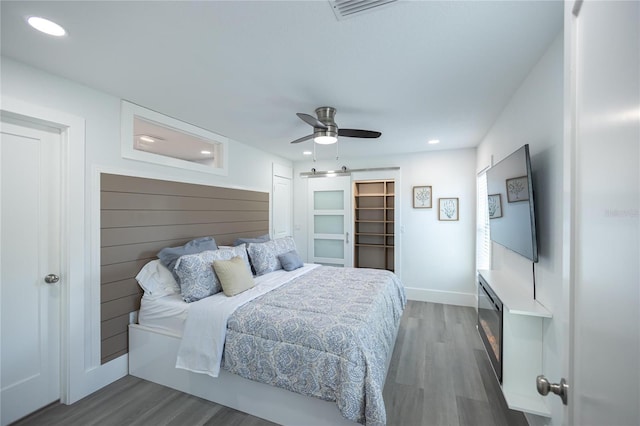 9716 28th St E, Parrish, FL 34219 - bedroom featuring wood finished floors, a ceiling fan, recessed lighting, and baseboards