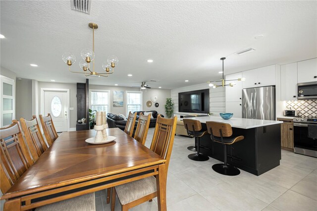 9716 28th St E, Parrish, FL 34219 - dining room with a chandelier, light tile patterned floors, a textured ceiling, recessed lighting, and a ceiling fan