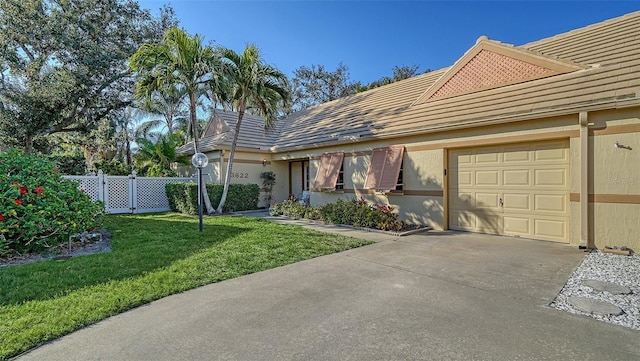 single story home with a garage and a front yard