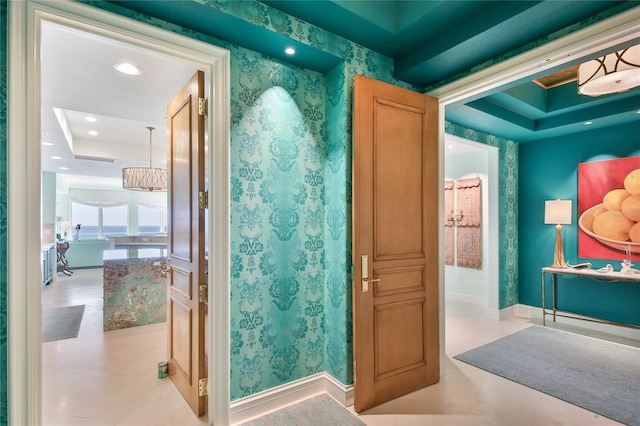 bathroom featuring recessed lighting, baseboards, a raised ceiling, and wallpapered walls