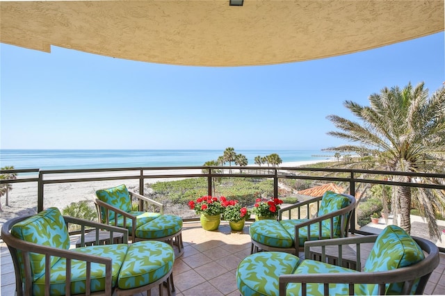 balcony with a water view and a beach view