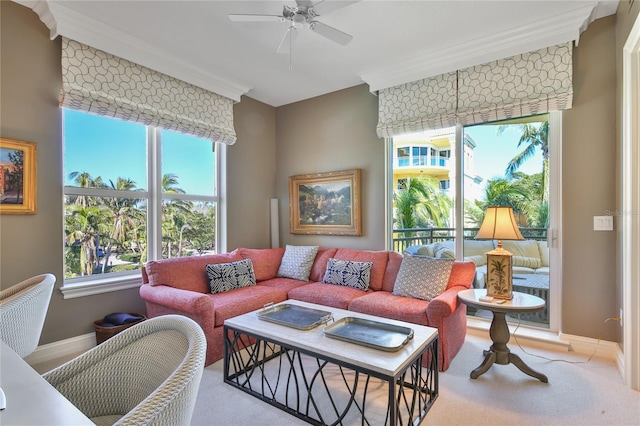 living room with crown molding, plenty of natural light, and ceiling fan