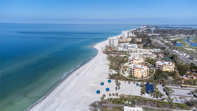 birds eye view of property featuring a water view and a view of the beach