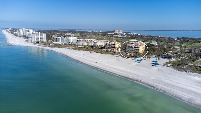 birds eye view of property with a city view, a view of the beach, and a water view