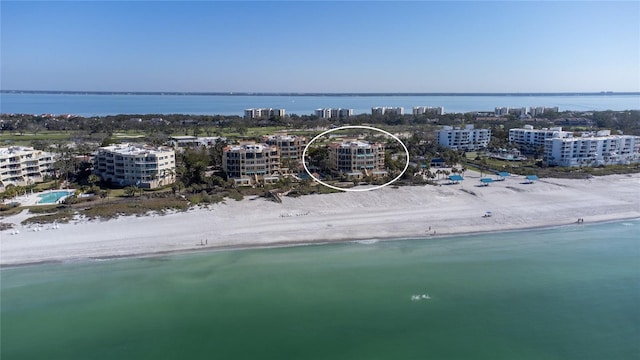 aerial view featuring a water view and a beach view