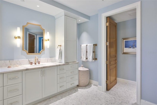 bathroom featuring baseboards and vanity