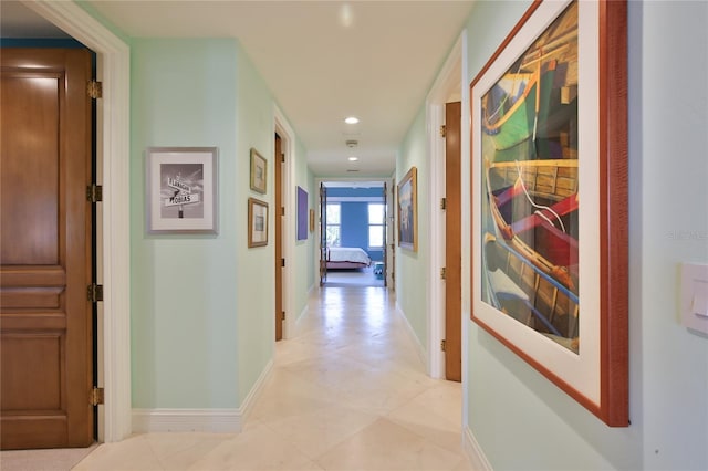 corridor featuring recessed lighting and baseboards