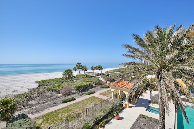 property view of water with a view of the beach and fence